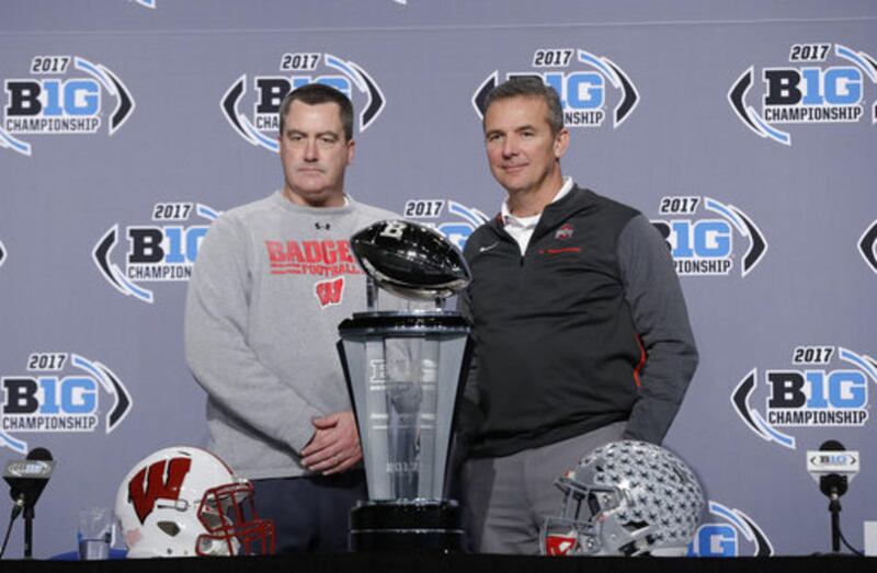 Wisconsin head coach Paul Chryst, left, poses with Ohio State head coach Urban Meyer during a news conference for the Big Ten Conference championship NCAA college football game, Friday, Dec. 1, 2017, in Indianapolis. Wisconsin will play Ohio State on Satu