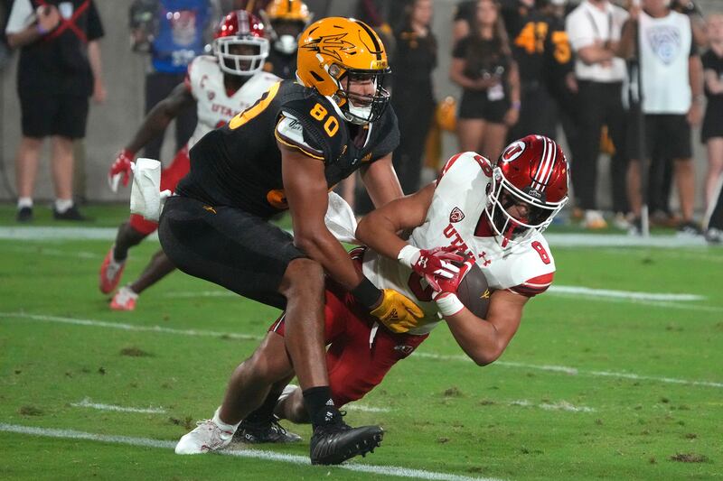 Utah safety Cole Bishop intercepts the ball, intended for Arizona State tight end Messiah Swinson