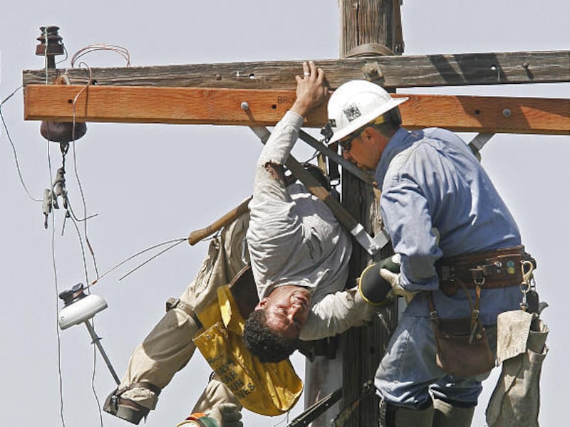 A worker rescues Fatu Matagi of Bountiful, a contractor who was caught in an electrical accident Tuesday.