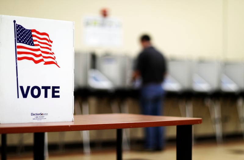 FILE - A voter casts his ballot in Georgia's 6th Congressional District special election at a polling site in Sandy Springs, Ga., Tuesday, June 20, 2017.