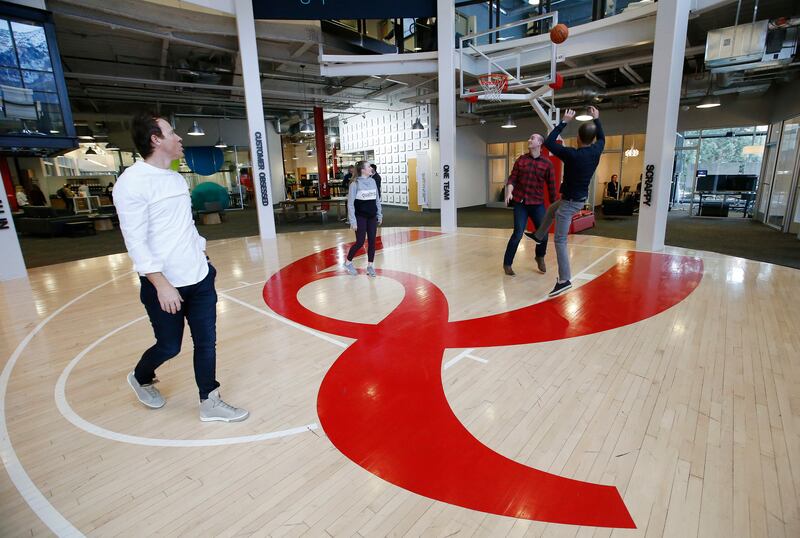 Qualtrics CEO Ryan Smith, left, plays basketball with employees at the business in Orem on Friday, Feb. 2, 2018.