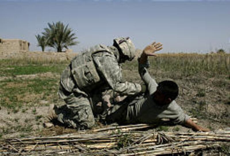 A U.S. soldier searches a man Monday outside Muqdadiyah, Iraq. Some experts fear a psychological health crisis among soldiers.