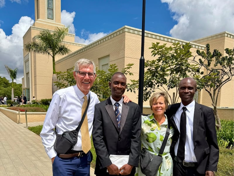 Kilford Shereni and Reginald Magocha pause for a photo with Bruce and Elizabeth Anderson outside the Harare Zimbabwe Temple.