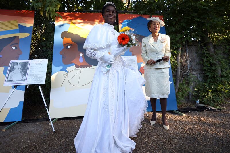 Ava Isom and Dr. Jackie Thompson pose for photos at an unveiling ceremony for a new mural featuring four Black women who lived and worked in the neighborhood in Richmond Park in Salt Lake City on Monday, June 27, 2022. Isom, 13, is dressed as 15-year-old Elnora M.J. Dudley, who was crowned queen of the 1898 Emancipation Day Celebration. Dudley is one of the four Black women featured on the mural. Thompson represents Mignon Barker Richmond, the first Black woman to graduate from college in Utah.