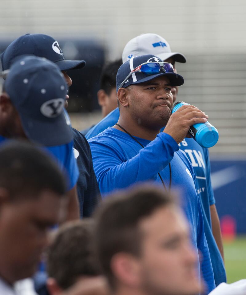 BYU defensive coordinator Ilaisa Tuiaki listens to the post-practice debriefing in Provo on Thursday, August 10, 2017.