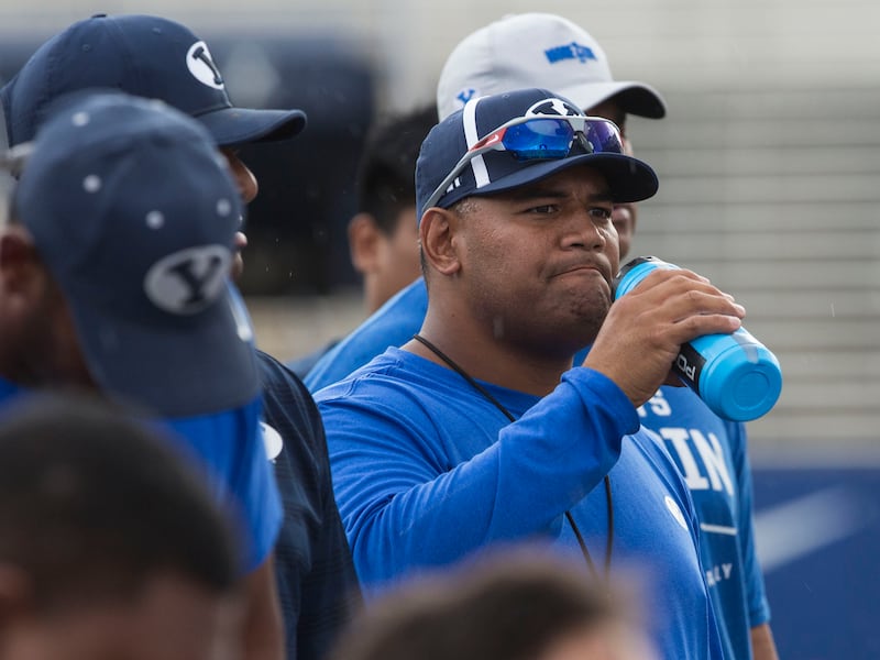 BYU defensive coordinator Ilaisa Tuiaki listens to the post-practice debriefing in Provo on Thursday, August 10, 2017.