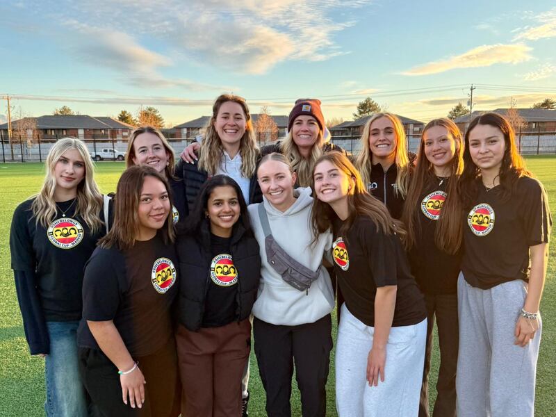 Eleven members of the She Belongs soccer team take a picture together outside in Salt Lake City on Jan. 25, 2025.