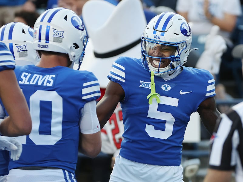 BYU receiver Darius Lassiter (5) celebrates a touchdown with quarterback Kedon Slovis in Provo on Oct. 21, 2023.