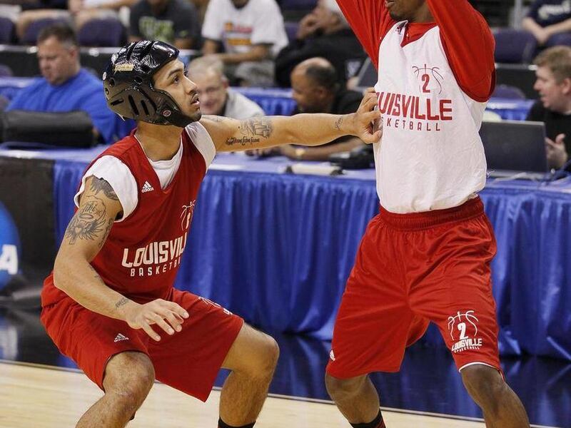 Louisville's Peyton Siva, left, defends teammate Russ Smith (2) during practice in Phoenix, Wednesday, March 21, 2012. Louisville will face Michigan State in an NCAA men's college basketball tournament West Regional semifinal on Thursday.