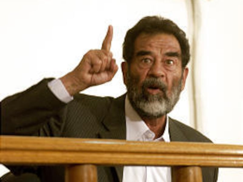 Saddam Hussein, in court last July, has not met with any of the 20 lawyers who claim to represent him.