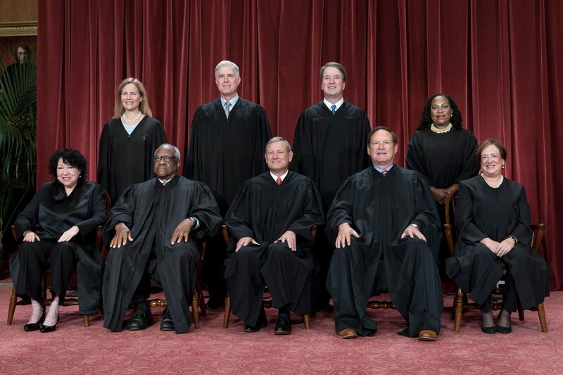 Members of the Supreme Court sit for a new group portrait at the Supreme Court building in Washington on Oct. 7, 2022.