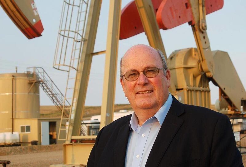 In this Aug. 31, 2012, photo Williston Mayor Ward Koeser stands near an oil well in Williston, N.D., Koeser, who has seen his town go from bust to boom over the past 18 years due to oil, will step down as mayor when his term ends in 2014.