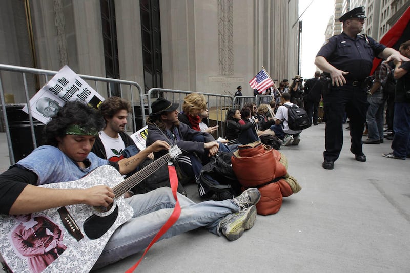 In this Sept. 17, 2011 photo, demonstrators affiliated with the Occupy Wall Street movement gather to call for the occupation of Wall Street in New York. Monday, Oct. 17, 2011 marked the one-month anniversary of the Occupy Wall Street movement.