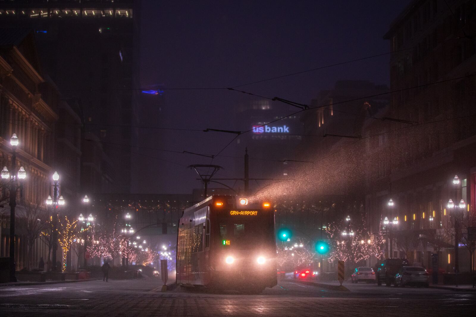 A Utah Transit Authority TRAX rail car’s light shines through a snow squall in downtown Salt Lake City early Monday evening.