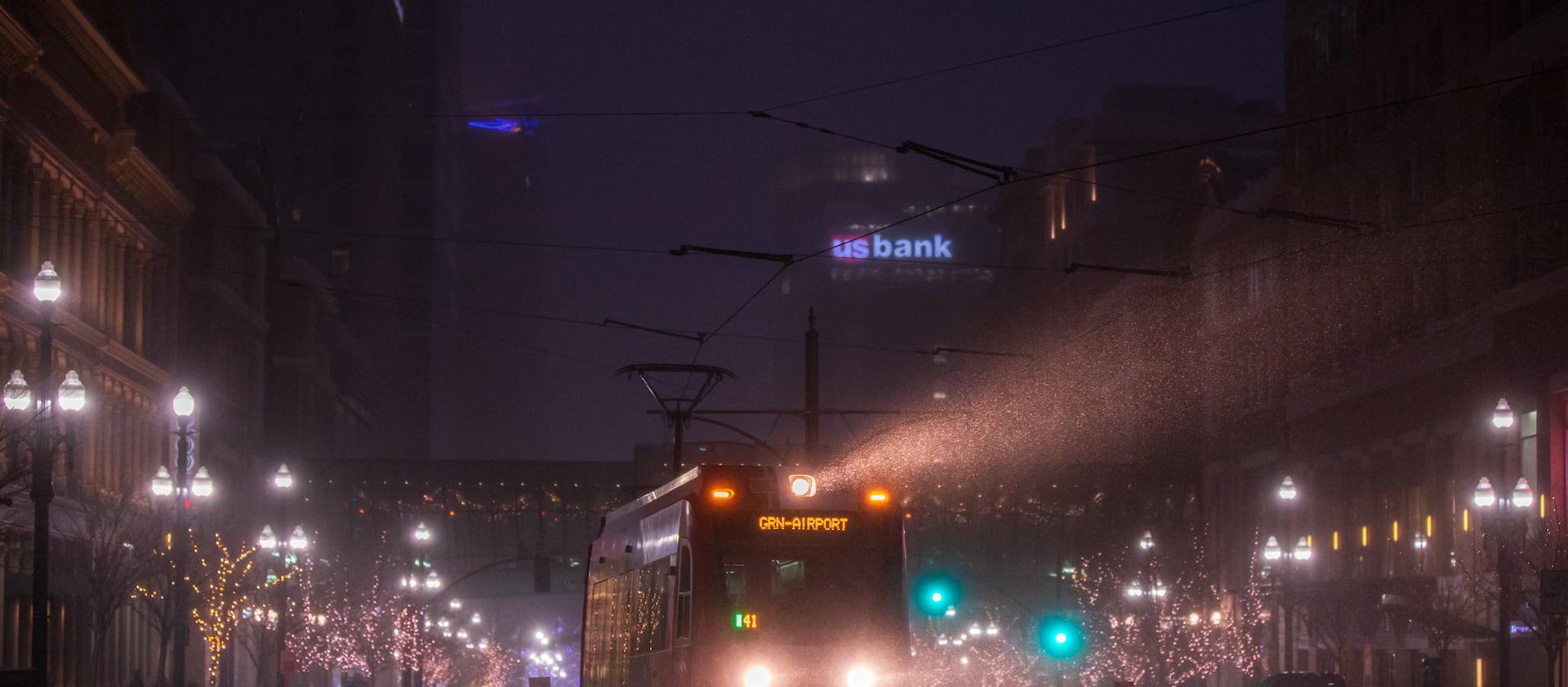 A Utah Transit Authority TRAX rail car’s light shines through a snow squall in downtown Salt Lake City early Monday evening.