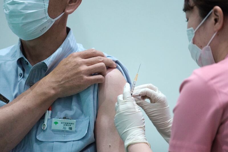 A Tokyo Metropolitan Government employee takes the Moderna’s COVID-19 vaccine shot.