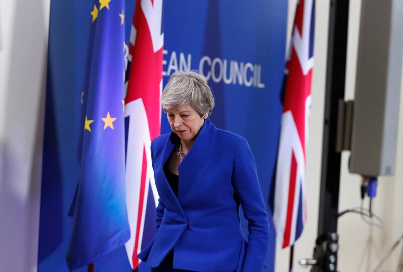 British Prime Minister Theresa May leaves the podium after addressing a media conference at the conclusion of an EU summit in Brussels, Thursday, April 11, 2019. European Union leaders on Thursday offered Britain an extension to Brexit that would allow th