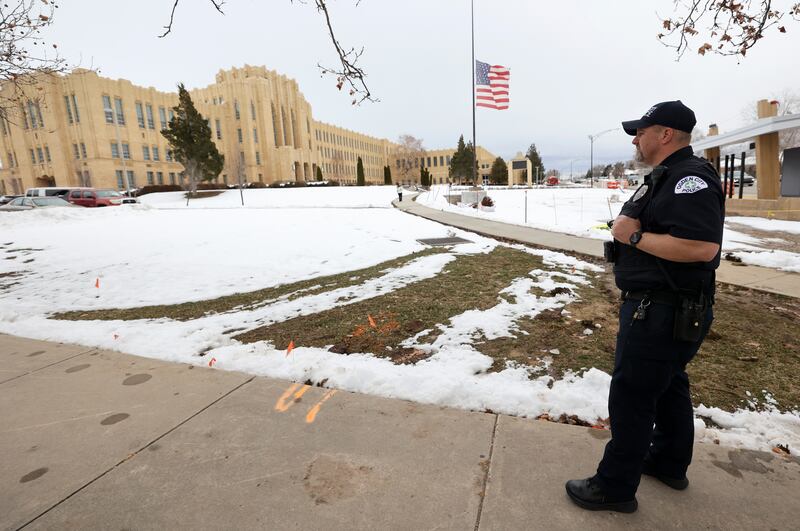 Ogden City Police officer Chavis Whitby stands outside of Ogden High School after false threats of shots fired on March 29, 2023.