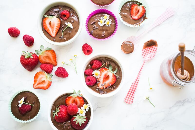 Banana Chia Mocha Protein Pudding and strawberries.
