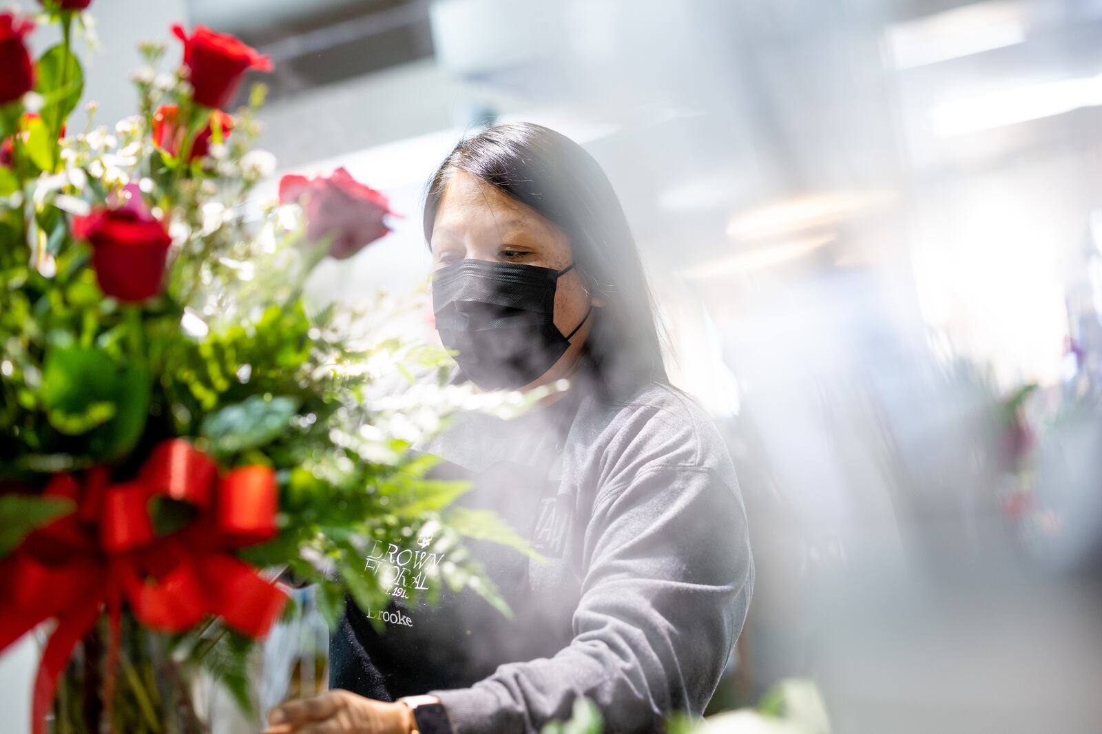 Floral designer Rhiannon Johnson works on a flower arrangement at Brown Floral in Holladay on Tuesday, Feb. 8, 2022.
