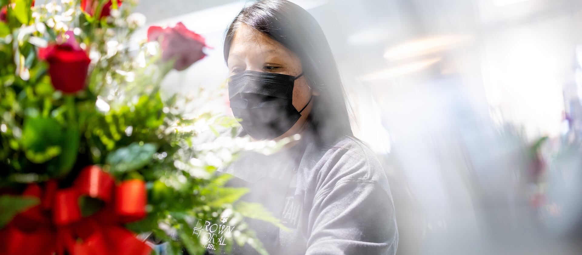 Floral designer Rhiannon Johnson works on a flower arrangement at Brown Floral in Holladay on Tuesday, Feb. 8, 2022.