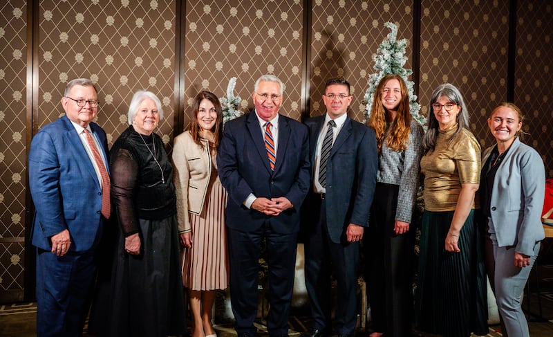 Elder Rubén V. Alliaud, president of the church's Europe Centra Area, center, and his wife, Sister Fabiana Alliaud, center left, pose for a photo with other guests at the first-ever Light the World dinner hosted by The Church of Jesus Christ of Latter-day Saints in Geneva, Switzerland, on Tuesday, Dec. 2, 2025.