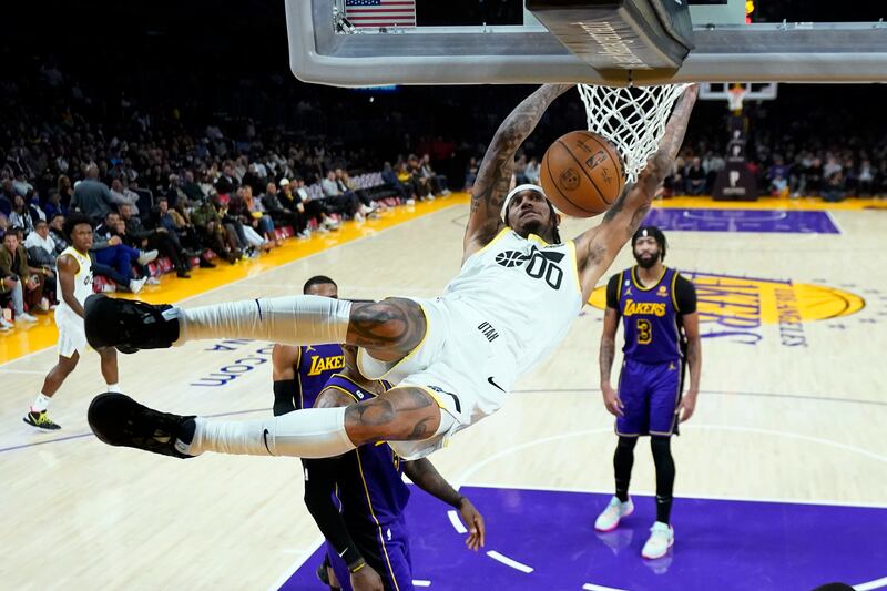 Utah Jazz guard Jordan Clarkson (wearing white) dunks