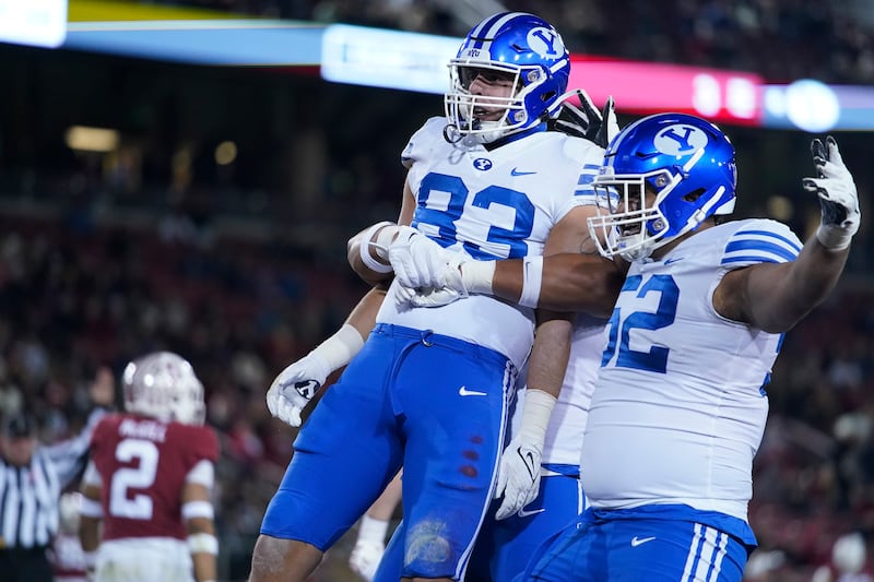 BYU tight end Isaac Rex (83) celebrates with teammates after scoring a 43-yard touchdown against Stanford.