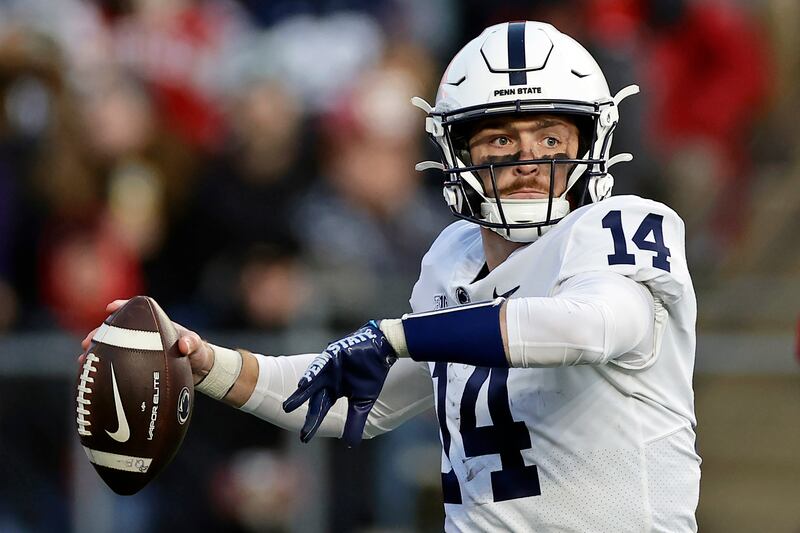 Penn State quarterback Sean Clifford (wearing white) passes
