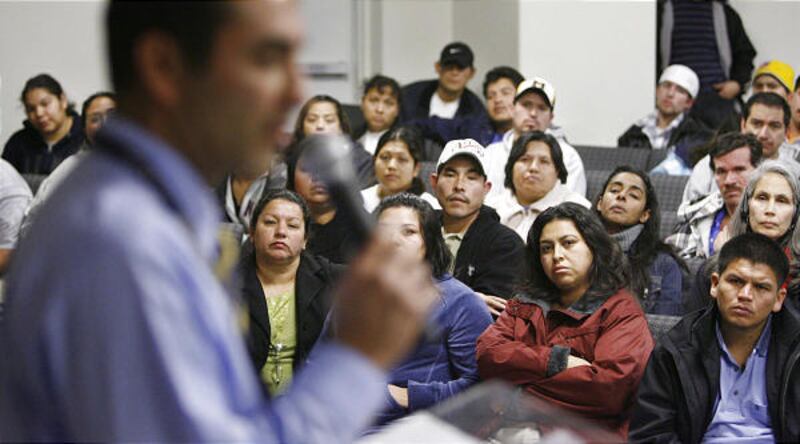 Jorge Sanchez of the Department of Workforce Services talks to members of the Hispanic community after the Swift plant raid.