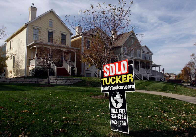 A “sold” sign is shown in front of a home in Carmel, Ind.