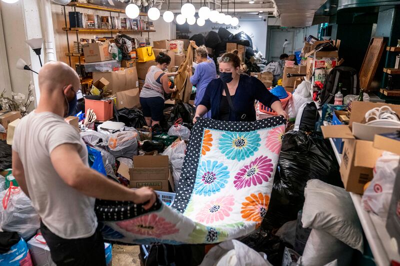 Volunteers sort items donated to refugees from Afghanistan.