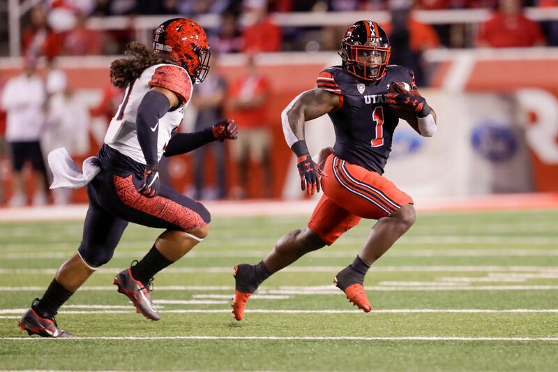 Jaylon Glover (1) of the Utah Utes runs away from Zyrus Fiaseun (51) of San Diego State on Saturday, Sept. 17, 2022.