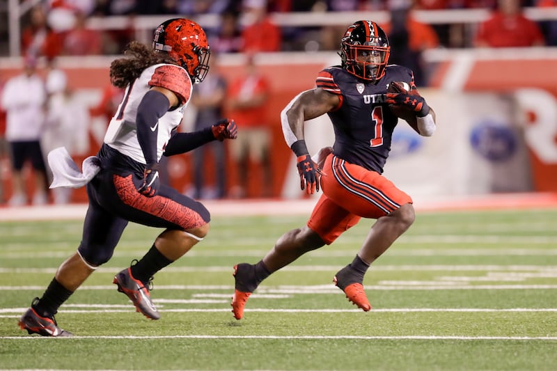 Jaylon Glover (1) of the Utah Utes runs away from Zyrus Fiaseun (51) of San Diego State on Saturday, Sept. 17, 2022.