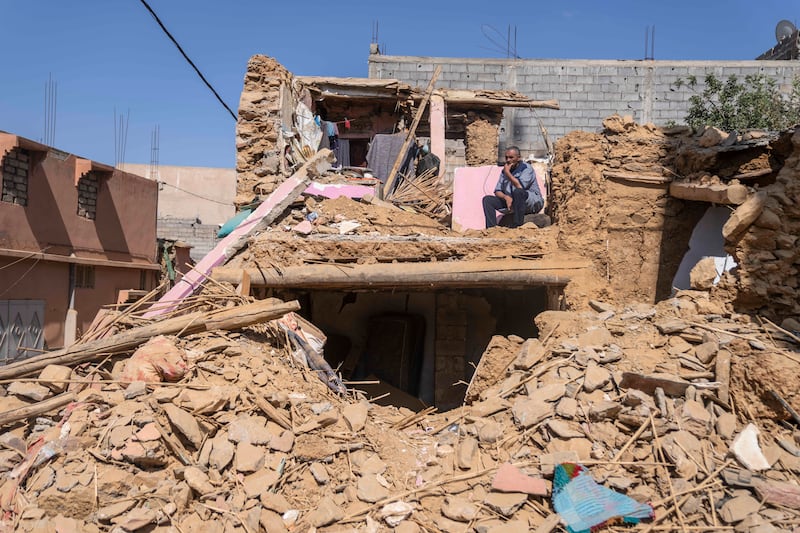 A man who lost his wife and daughter in the earthquake sits in what used to be his home outside Marrakech, Morocco, on Sept. 14, 2023.
