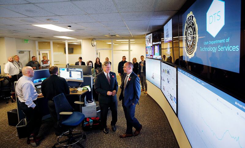 FILE - Mike Hussey, left, chief information officer and executive director of the Utah Department of Technology Services, shows Lt. Gov. Spencer Cox the Utah Cyber Center at the Capitol in Salt Lake City on election night, Tuesday, Nov. 6, 2018.