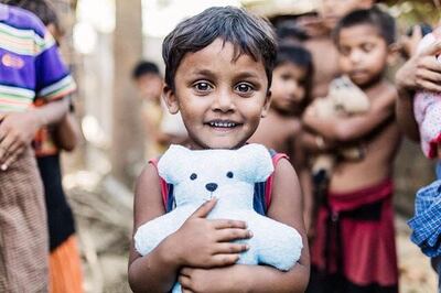A child in Bangladesh poses with a stuffed bear he received from Dolls of Hope. Since its creation in 2015, Dolls of Hope has donated over 9,000 handmade stuffed toys to children in need all around the world.