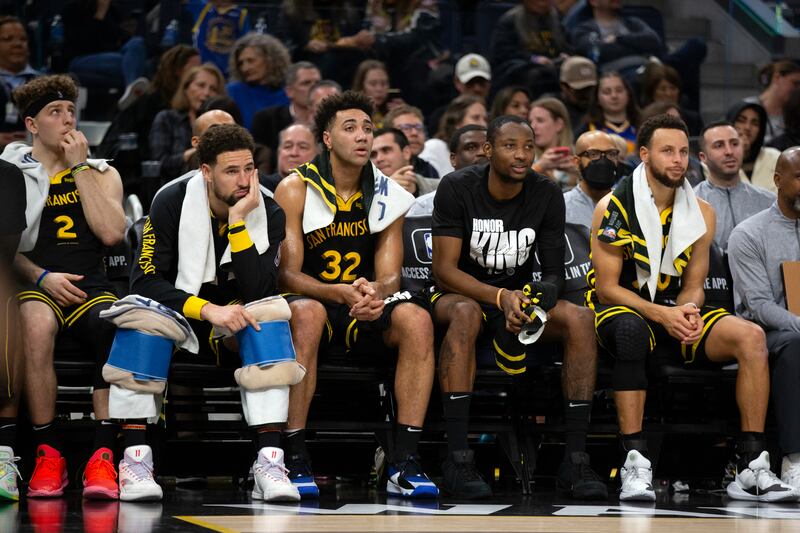 The Golden State Warriors bench watches the closing minutes an NBA basketball game against the New Orleans Pelicans on Jan. 10, 2024.