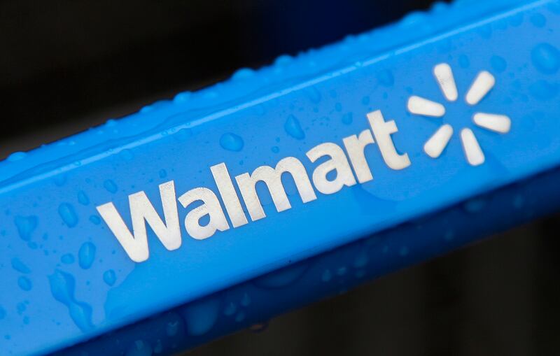 This photo shows the rain-soaked handle of a shopping cart outside a Walmart store.