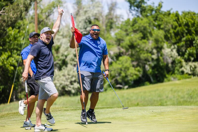 BYU football head coach Kalani Sitake and his teammates celebrate