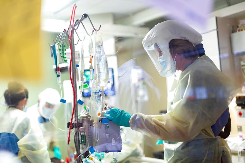 Registered nurse Jack Kingsley attends to a COVID-19 patient at St. Luke’s Boise Medical Center in Boise, Idaho.