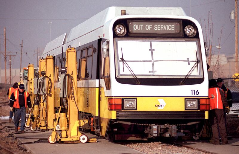 FILE - Workers place the new cars on the tracks at the UTA yards in Midvale.
