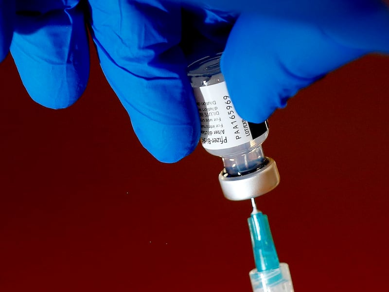 A photo of the Pfizer-BioNTech COVID-19 vaccine is drawn into a syringe.