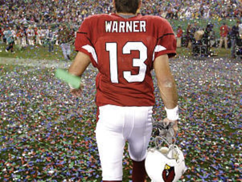 Arizona Cardinals quarterback Kurt Warner walks through the confetti following the Cardinals' loss to Pittsburgh in Super Bowl XLIII.