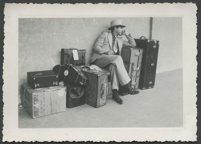 Ray Henry Zenger, a missionary who served in the Brazilian Mission between 1936 and 1939, sits with his and other missionaries' luggage as they prepare to depart for Brazil in November 1936.
