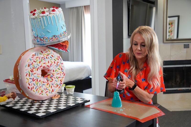 RaChelle Hubsmith uses a blowtorch on her cake, as seen on “Bake It ’Til You Make It,” Season 1.