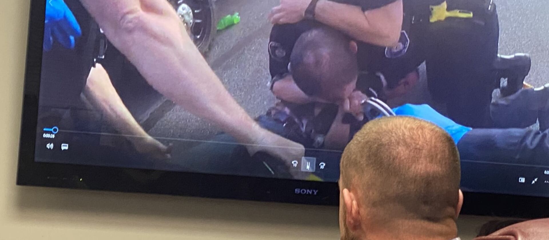 Cody Greenland watches body camera video of his arrest in 2020 from his attorney’s office in Salt Lake City on Tuesday, March 1, 2022.