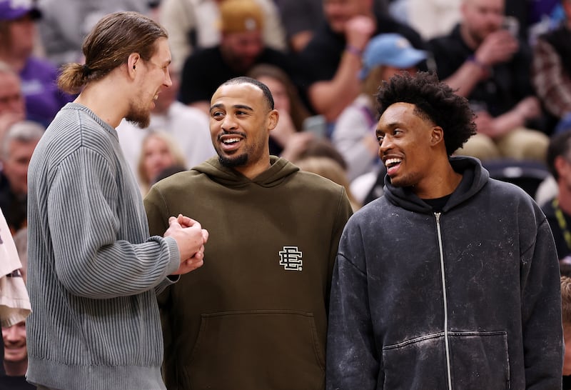 Utah Jazz forward Kelly Olynyk, left, guard Talen Horton-Tucker, center, and guard Collin Sexton talk during a timeout.