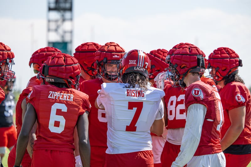 Cam Rising huddles up the offense during practice at the University of Utah practice facility in Salt Lake City.
