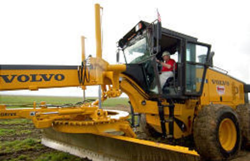 Larry H. Miller operates a piece of heavy equipment during groundbreaking on Wednesday for the Miller Motorsports Park at Deseret Peak in Tooele County.